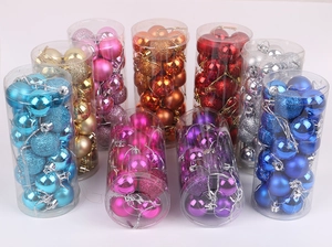 Close-up of assorted plastic Christmas balls in matte and glitter finishes in clear tubes