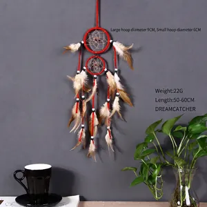 Handmade red dream catcher with double hoops and feathers for home wall decoration