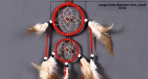 Detail of red dream catcher with 9cm double rings, brown beads and natural feathers