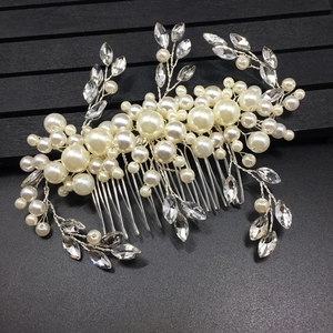 Macro detail of handmade bridal hair comb with pearls and marquise rhinestones