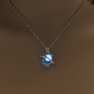 Luminous arrow pendant necklace with glowing blue bead on a silver chain for women