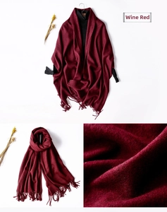 Detailed close-up of wine red scarf fabric texture and elegant tassel trim design