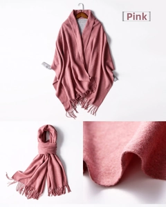 Macro shot of dusty pink knitted scarf showing soft texture and long fringe details