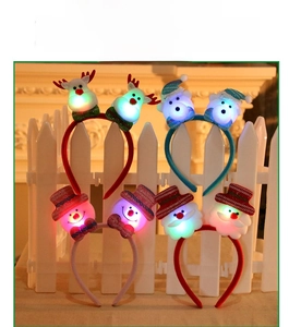 Detail showing glowing LED Christmas headbands with reindeer, bear, and Santa designs