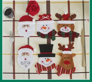 Christmas silverware holder featuring felt Santa, snowman, and reindeer on a table