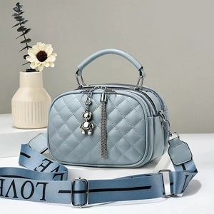 Light blue quilted leather crossbody bag with triple zippers and woven LOVE strap