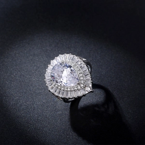 Macro detail of tear-drop cubic zirconia ring with brilliant halo pave setting