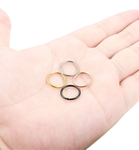 Detail view of 4 small stainless steel hoop rings in gold silver rose gold and black colors