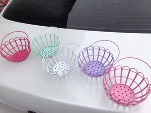 Row of five colorful mini wire storage baskets in pink, green, white, purple, and rose