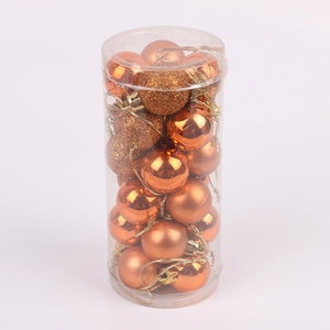 Detail of assorted bronze Christmas ornaments in transparent cylindrical packaging