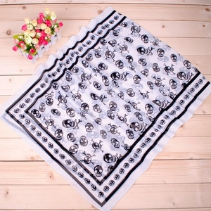 Classic black and white pirate skull print long chiffon scarf on a wood background