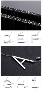 Detailed close-up of 26 diamond-encrusted silver letter pendants on stainless steel chains