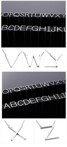 Macro detail of alphabet pendant necklaces with sparkling diamonds and steel chain
