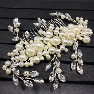 Detailed macro of handmade bridal hair comb with ivory pearls and marquise rhinestones