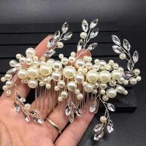 Detailed view of handmade bridal hair comb with pearls and leaf-shaped crystals