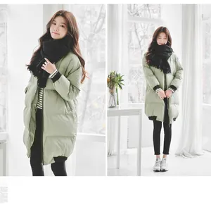 Detail of solid black scarf with tassels paired with light green long down jacket