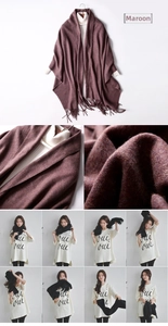 Macro detail of the woven texture and soft fringe on the purplish red wool shawl