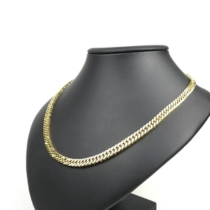 Flat golden Cuban link chain necklace displayed on a black neck mannequin base