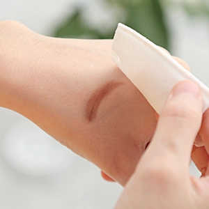 Soft square cotton pads for makeup removal and facial cleansing shown in use