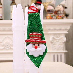 Green sequined Christmas tie with Santa Claus figure on a white fence decoration