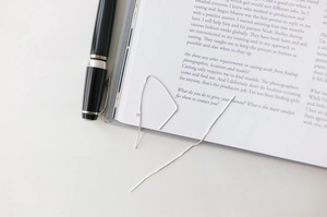 Minimalist S925 sterling silver box chain drop earrings on a magazine with a pen