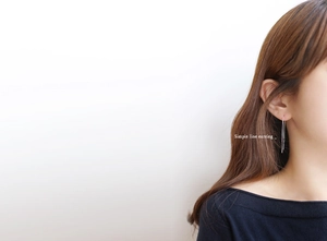 Close-up of a minimalist S925 sterling silver long box chain earring on a model ear
