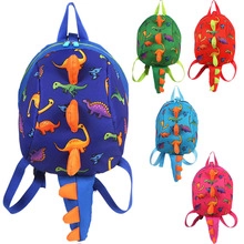 Detail of 3D dinosaur tail and spikes on colorful cartoon toddler backpacks