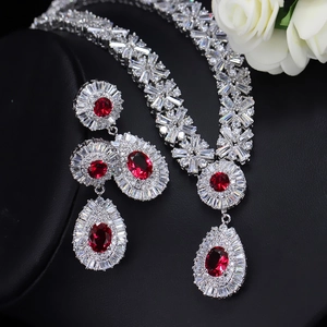 Macro shot of bridal necklace set with red teardrop stones on black background
