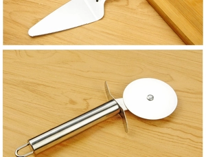 Detail of stainless steel pizza cutter wheel and serrated cake server on wood surface