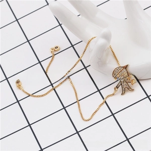 Detailed close-up of adjustable gold bracelet featuring a micro-paved zircon boy charm