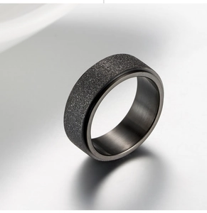 Mens black rotatable stainless steel ring with sandblasted matte finish and polished edges