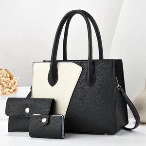 Detailed view of 3-piece tote bag set with black and white contrast leather texture