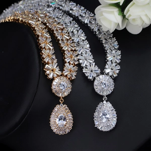 Luxurious gold and silver necklaces set with AAA zircon drop pendants on elegant display
