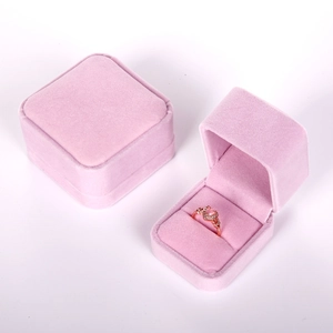 Pink velvet jewelry box showing open and closed views with a heart-shaped ring