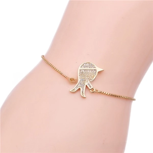 Detail of adjustable gold box chain bracelet with sparkling zircon cartoon pendant