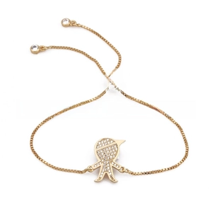 Detail of adjustable gold-plated bracelet with a zircon-encrusted cartoon boy charm