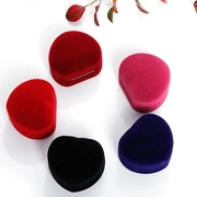 Top view of heart-shaped velvet jewelry boxes in red, pink, purple, and black colors