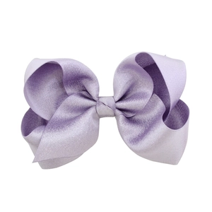 Handmade purple satin bow hair clip for girls with elegant glossy fabric texture