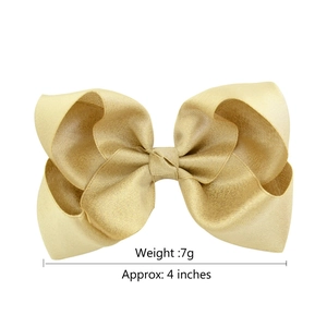 Golden 4-inch satin bow hair clip for girls, 7g lightweight accessory on white background