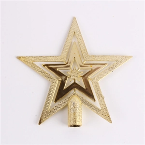 Close-up of golden glittered Christmas tree topper star with multi-layer design