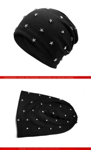 Detail of black knit beanie featuring silver star studs and soft cotton texture