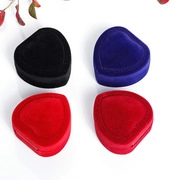 Detailed top view of velvet heart-shaped jewelry boxes in red, black, and blue colors