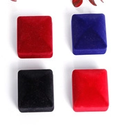 Detailed view of red, blue and black velvet square jewelry gift boxes for rings