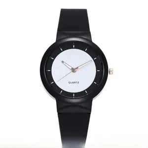 Close-up of a minimalist quartz sports watch featuring black silicone strap and dial