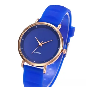 Detail of slim blue silicone strap and rose gold quartz watch on a display stand