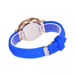 Detail view of a bright blue silicone strap with rose gold metal case and pin buckle