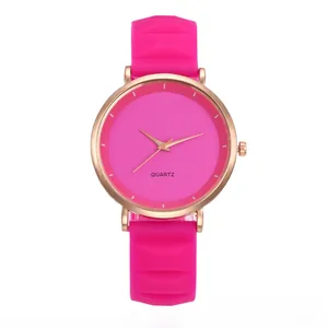 Detail view of pink silicone watch band with diamond texture and rose gold case
