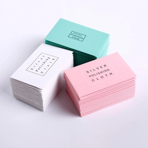 Detailed macro view of mint, white, and pink jewelry polishing cloths for silver care