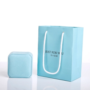 Light blue jewelry gift set featuring a velvet ring box and matching paper carrier bag