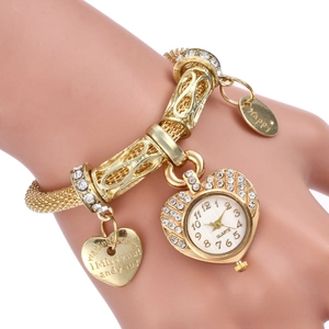 Detail of gold heart quartz watch featuring rhinestone inlay and I Miss You heart charm
